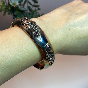 Vintage hinged gold bracelet swirling clouds design